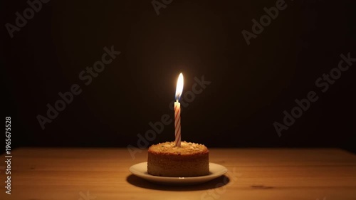 Single Candle on Cake in Dark Minimal Scene
