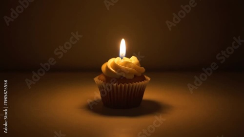 Cupcake with Candle in Warm Dark Background
