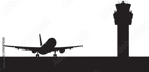 Silhouette airplane on runway next to airport control tower
