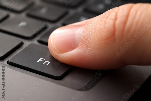 Finger Pressing Fn Key on Laptop Keyboard