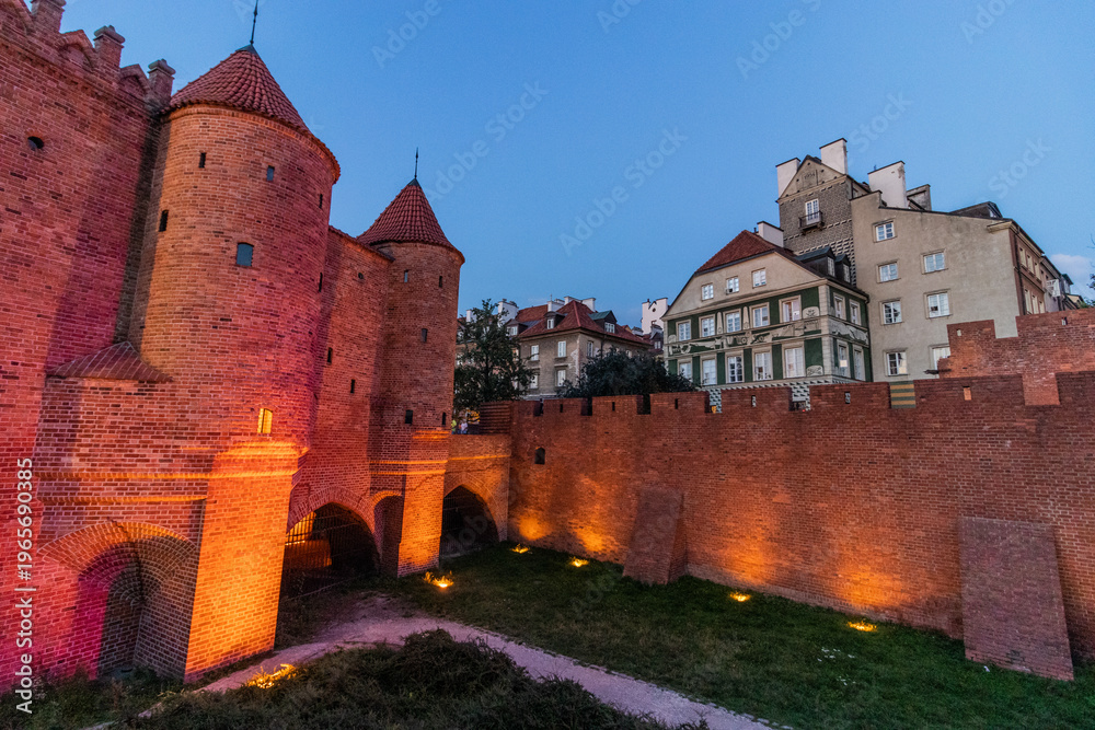 Fototapeta premium WARSAW,POLAND - AUGUST 3, 2022: Evening view of the Warsaw Barbican, part of the city fortification, Poland