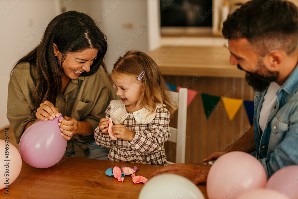 Fototapeta premium Family enjoying happy moments decorating with balloons for a celebration