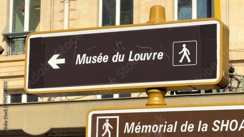 Pedestrian wayfinding sign for the Louvre Museum located in the Le Marais district in Paris, France