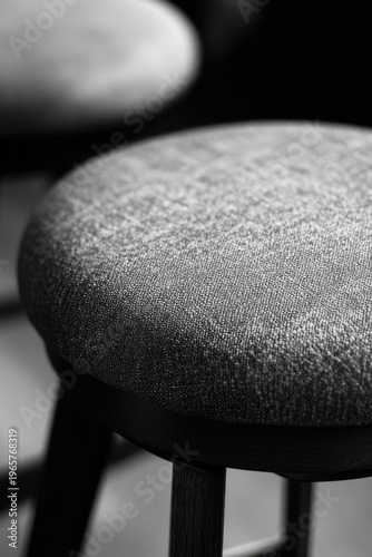 A pair of antique stools with intricate carvings in a classic black and white photograph
