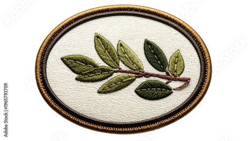 An embroidered oval of a detailed olive branch. The framed art showcases leaves, stitched to create a realistic effect of depth and texture