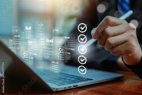 Fotografie Business professional using stylus on laptop with digital checklist interface, data analytics dashboard, task management, workflow automation, project planning and modern business technology concept