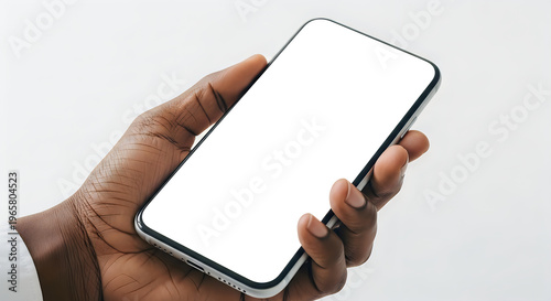 A hand holding a smartphone with a blank white screen isolated on white background