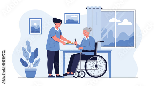 Kind young caregiver in a blue uniform serving food to an elderly woman in a wheelchair at a table in a bright nursing home room.