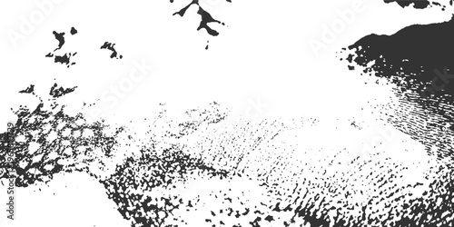 Abstract monochrome textured background with scattered dark irregular shapes and granular patterns on white