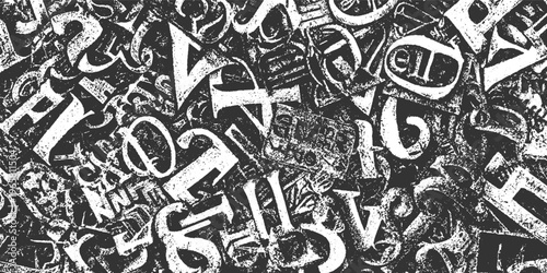 Chaotic jumble of distressed white gothic alphabet letters on a dark textured background font typography