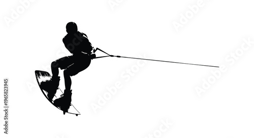 Waterskier performing a trick mid air a striking black silhouette