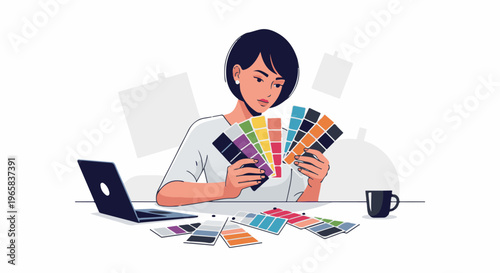 Designer selects colors from swatches, with laptop and coffee nearby