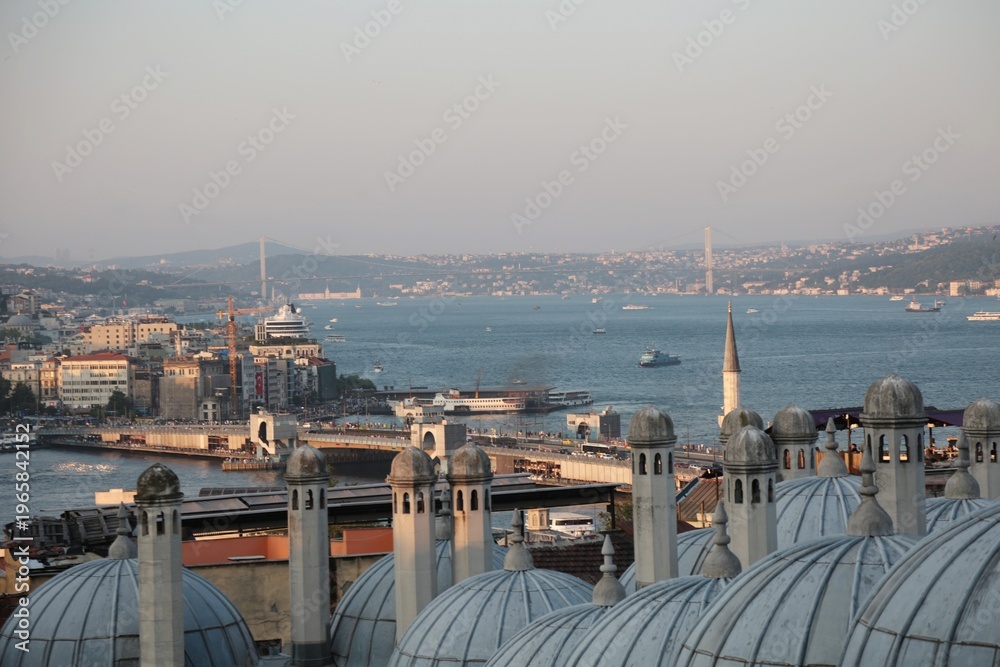 Obraz premium Istanbul cityscape behind the domes of Suleymaniye Mosque in Istanbul, Turkey, June, 2025. Panaromic view of Istanbul skyline behind the domes of Suleymaniye mosque, showcasing Ottoman architecture.