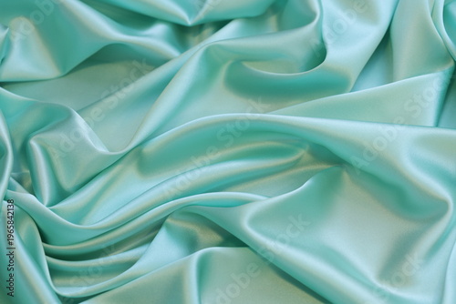 Canvastavla Top view flat lay of mint green luxurious 16 momme pure silk satin fabric with elegant soft drapes and a high-gloss reflective sheen, ideal for premium fashion backgrounds and textile textures