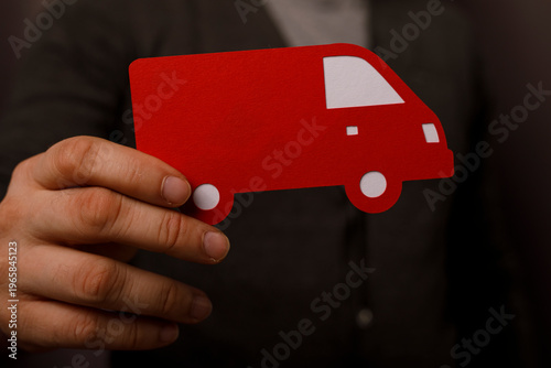 Hand holding a red cardboar...