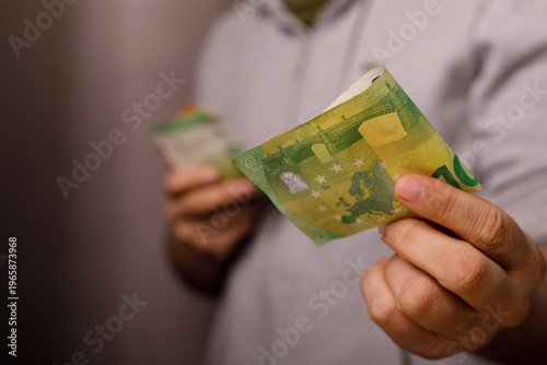Person holding Euro banknot...