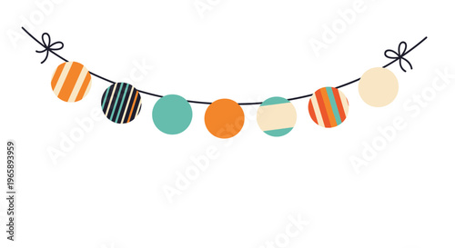 Festive garland made of colorful patterned paper balls hanging on a dark string is isolated on a white background.