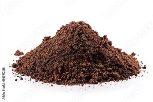 Ground coffee in a mound on a plain white surface