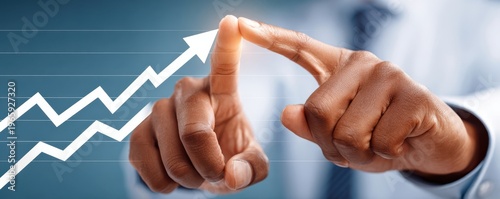 Business growth concept: close-up of professional hand pointing at upward-trending graph