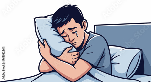 Sad young man crying into pillow in bed