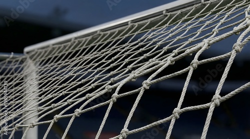 Football goal net in dynamic perspective creating modern sport background.