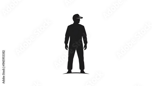 Silhouette of a man wearing a baseball cap standing alone