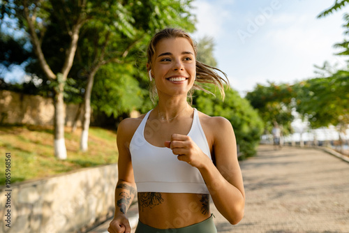 pretty young blond smiling woman doing sport exercises in morning park