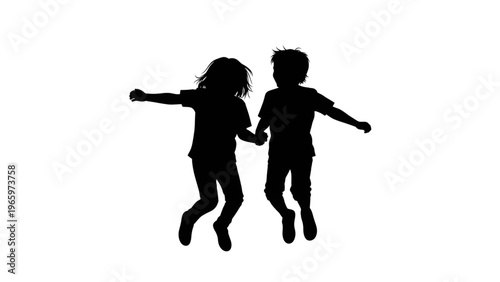 Silhouette of two happy children jumping hand in hand together