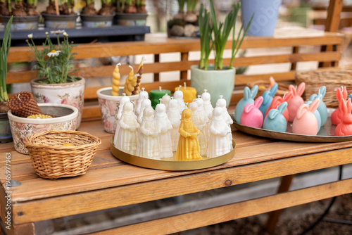 Wallpaper Mural Easter exterior market stall with spring flowers, wicker baskets, bunny shaped candles, and festive decorations. Cozy outdoor garden shop with blooming plants in pots and seasonal holiday display. Torontodigital.ca