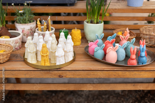 Wallpaper Mural Easter exterior market stall with spring flowers, wicker baskets, bunny shaped candles, and festive decorations. Cozy outdoor garden shop with blooming plants in pots and seasonal holiday display. Torontodigital.ca