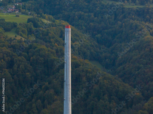 This aerial view shows the tall chimney of an old coal power plant in Trbovlje, Slovenia, now inactive and part of energy transition.