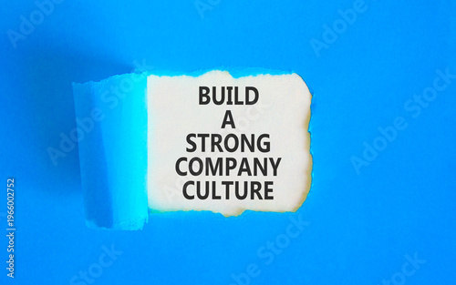 Strong company culture symbol. Concept words Build a strong company culture on beautiful white paper. Beautiful blue paper background. Business strong company culture concept. Copy space.