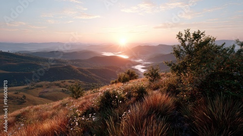 Sunrise Over the Mountains: A breathtaking view of rolling hills and valleys beneath a colorful sky, as the sun rises, casting a warm glow over the landscape. 