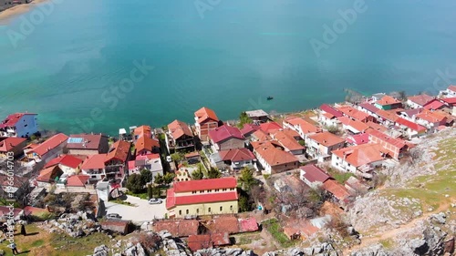 Village of Lin on the Rocky Peninsula Edge Along the Beautiful Shoreline of Lake Ohrid surrounded by emerald calm waters