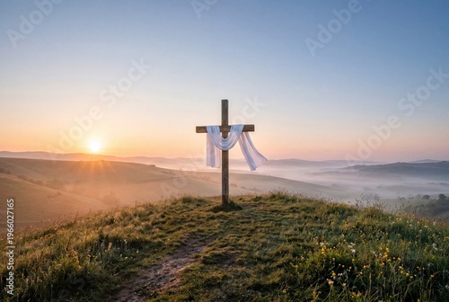 Wooden cross draped with white cloth standing on a hill at sunrise above a misty valley, symbolizing faith, resurrection, hope, Easter morning, peace, devotion, and spiritual reflection.