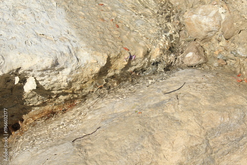 Photography Water seeping through porous rock surface in arid Mediterranean terrain close up