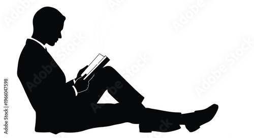silhouette of man sitting reading book