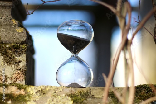 Old park and hourglass time is passing concept hurry up be in time old and modern 