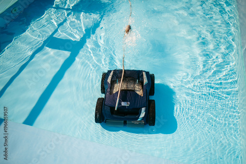 Fotografie Robotic pool cleaner working underwater to keep swimming pool clean