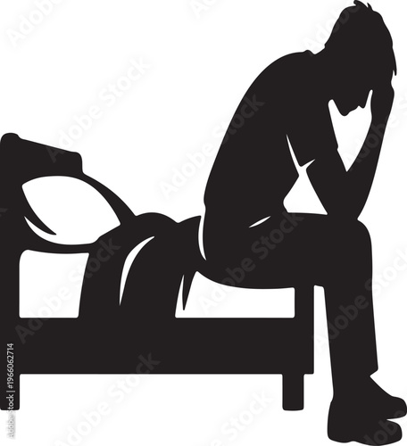 A silhouette of a man sits with his head in his hand on a chair conveying feelings of sadness and despair