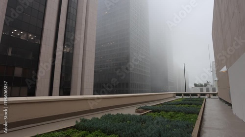 Foggy Rooftop Walk With Office Towers