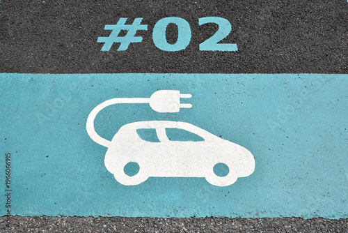 Electric vehicle charging station sign on asphalt