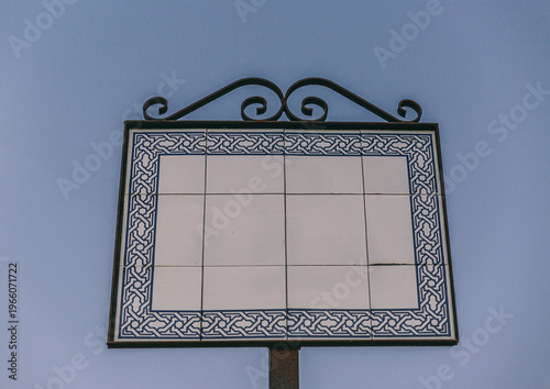 Blank ceramic tile sign with ornate metal frame