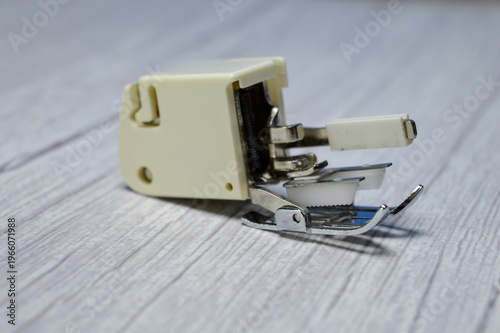 Fotografie Close-up of sewing machine presser foot attachment