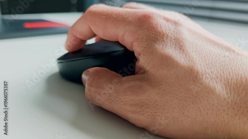 Hand of working person holding computer mouse on desk, office workspace detail with modern technology and everyday productivity concept. Work concept. 4K video footage