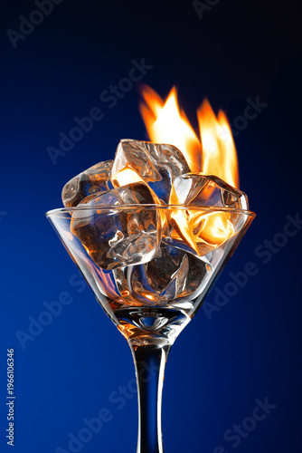 fire in a glass with ice cubes, isolated on a black background