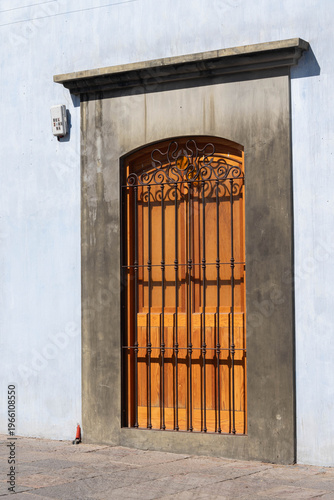 Traditional Wooden Window with Decorative Iron Grate in Oaxaca