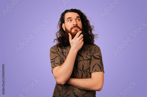 Принти на полотні Thoughtful Man Stroking Beard And Pondering, Curly Hair And Patterned Shirt On P