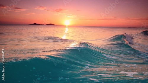 Ocean waves crash at sunset on a tropical island with distant mountains