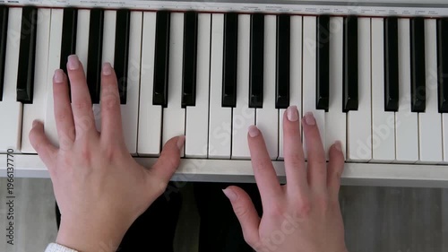 Female hands playing the piano